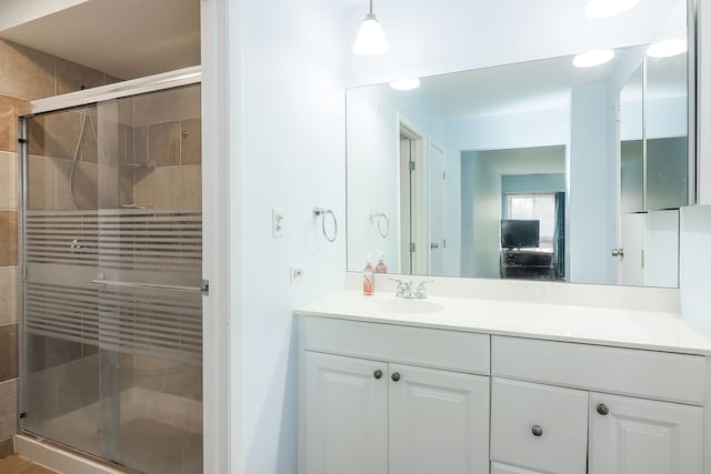 bathroom featuring vanity and an enclosed shower