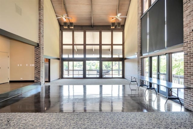 kitchen with french doors, ceiling fan, a towering ceiling, beam ceiling, and wood ceiling