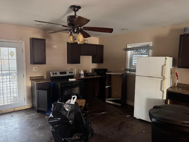 kitchen featuring electric stove, a healthy amount of sunlight, dark hardwood / wood-style flooring, and white fridge