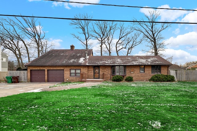 ranch-style house featuring a garage and a front yard