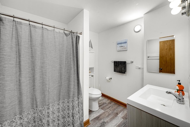 bathroom featuring hardwood / wood-style flooring, vanity, and toilet