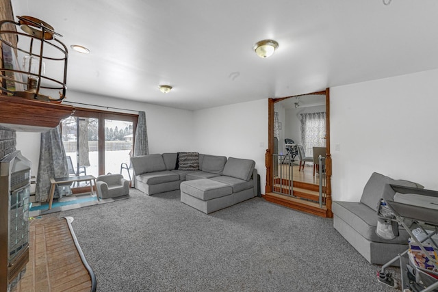 living room featuring a fireplace and carpet