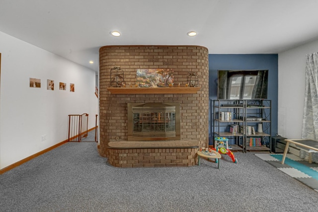 living room with carpet flooring and a brick fireplace