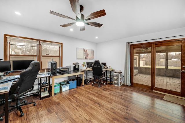 home office with hardwood / wood-style floors and ceiling fan