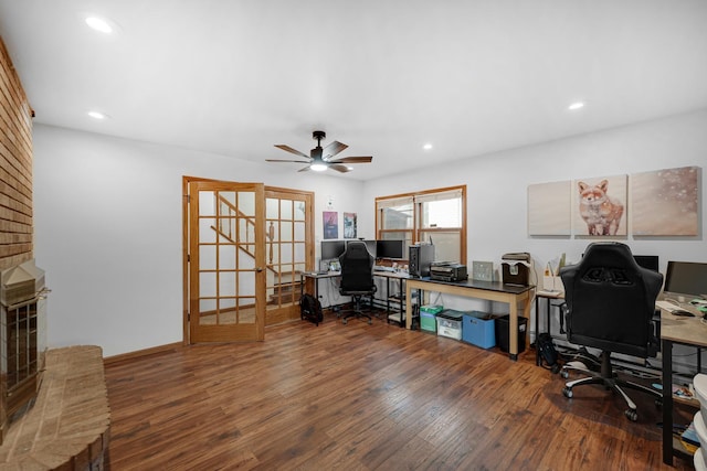 office area featuring french doors, dark hardwood / wood-style floors, a brick fireplace, and ceiling fan