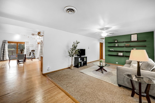 living room with hardwood / wood-style floors and ceiling fan