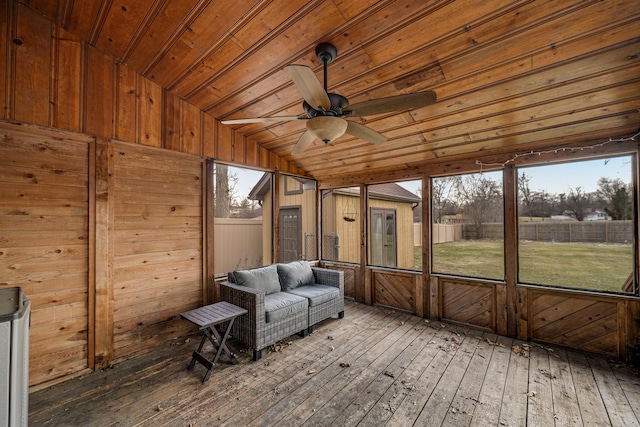 unfurnished sunroom with ceiling fan, lofted ceiling, and wooden ceiling