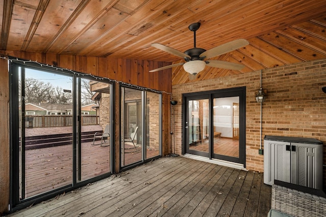 unfurnished sunroom with ceiling fan and vaulted ceiling