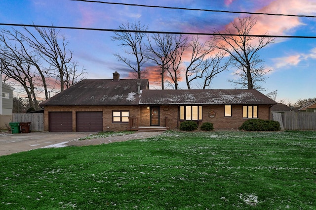 view of front of house with a yard and a garage