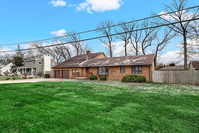 view of front of property with a garage and a front lawn