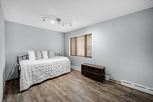 bedroom featuring wood-type flooring and a baseboard radiator