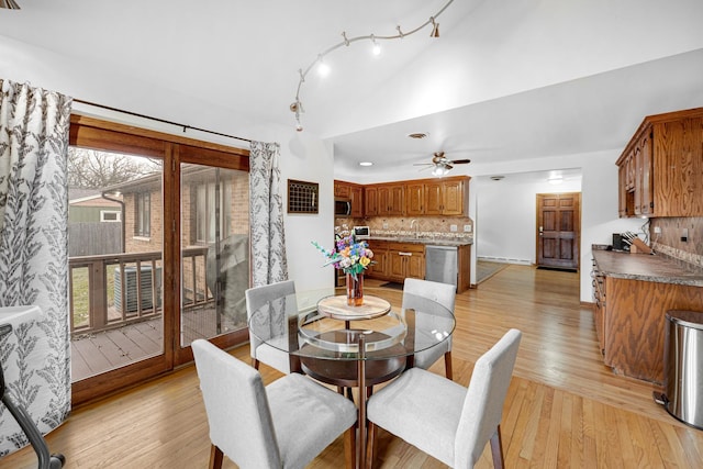 dining room featuring a wealth of natural light, light hardwood / wood-style flooring, ceiling fan, and sink