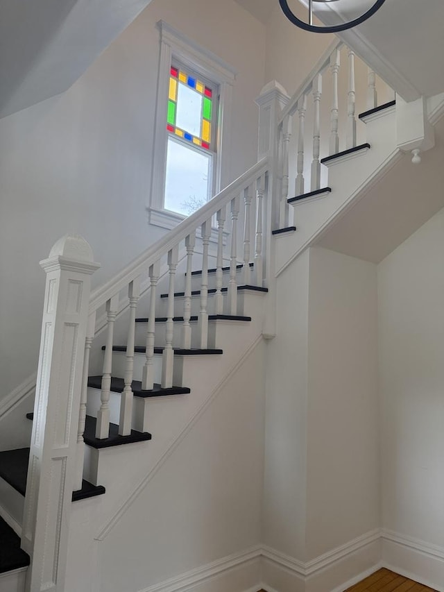 staircase with hardwood / wood-style flooring