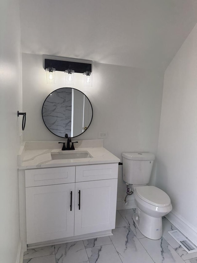 bathroom with vanity and toilet