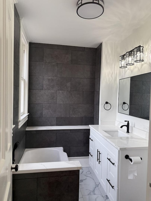 bathroom featuring vanity, a healthy amount of sunlight, and tile walls