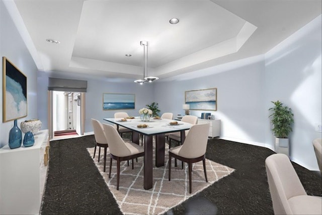 dining area with a tray ceiling