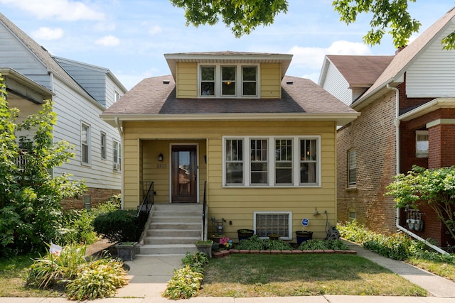 bungalow-style house with a front lawn