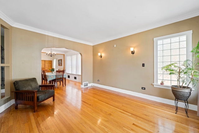 interior space featuring crown molding, hardwood / wood-style floors, and a notable chandelier