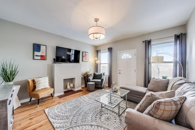 living room featuring light hardwood / wood-style floors and a healthy amount of sunlight