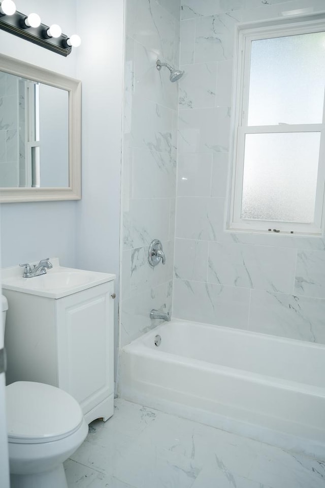 full bathroom with vanity, tiled shower / bath combo, and toilet