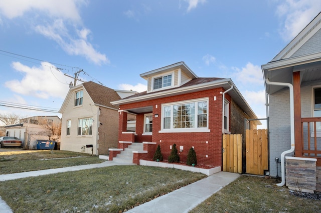 bungalow-style home featuring a front lawn