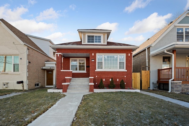 bungalow-style home featuring a front lawn