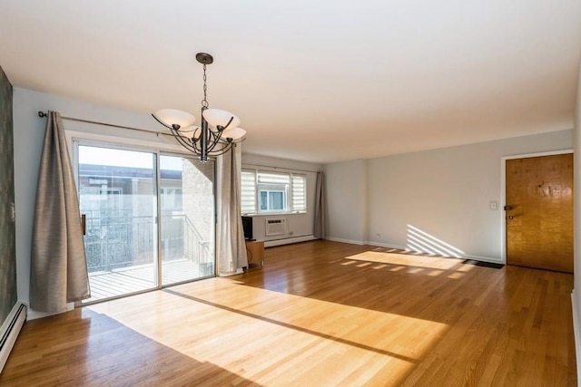 unfurnished dining area featuring wood-type flooring, a baseboard radiator, and a chandelier