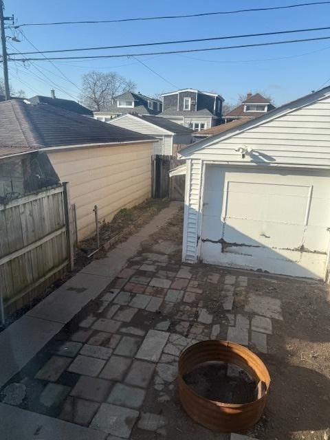 view of patio / terrace with a garage and an outdoor structure