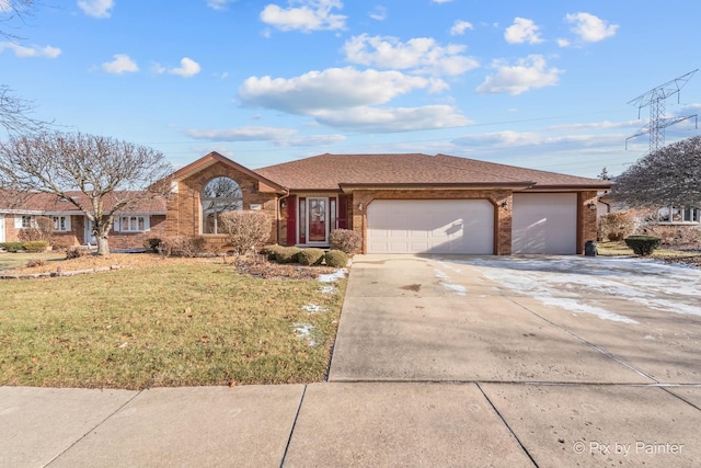 ranch-style home featuring a front yard and a garage