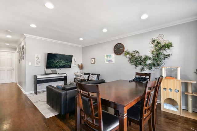 dining area featuring hardwood / wood-style flooring and crown molding