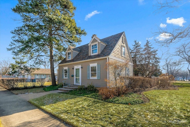 cape cod home featuring a front lawn