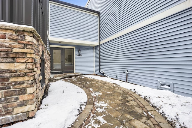 snow covered patio with french doors