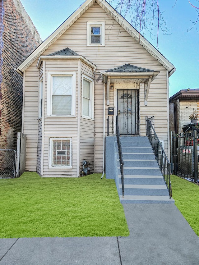 bungalow-style home featuring a front yard