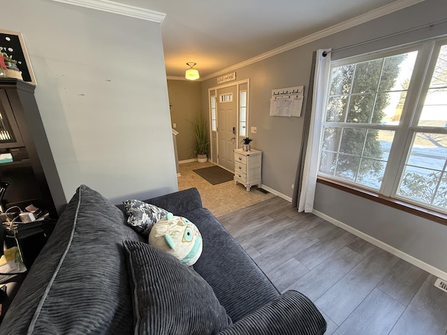 living room with light wood-type flooring and ornamental molding