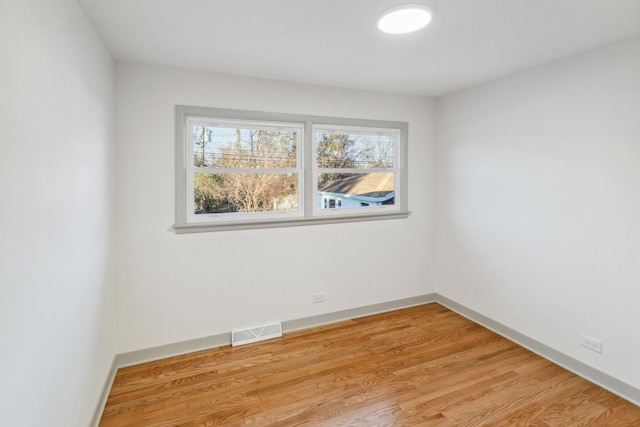 spare room featuring light hardwood / wood-style floors