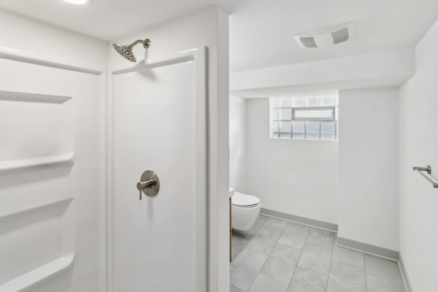 bathroom featuring toilet and a shower