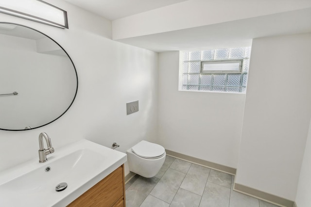 bathroom with tile patterned flooring, vanity, and toilet