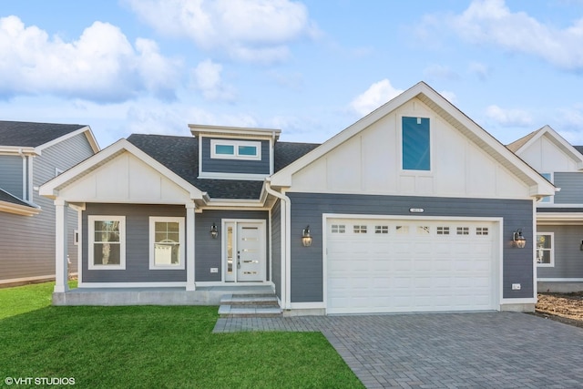 view of front of house with a garage, covered porch, and a front yard