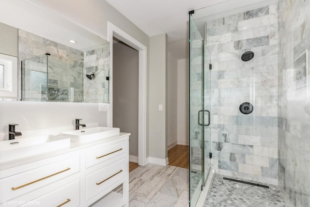 bathroom with vanity and a shower with shower door