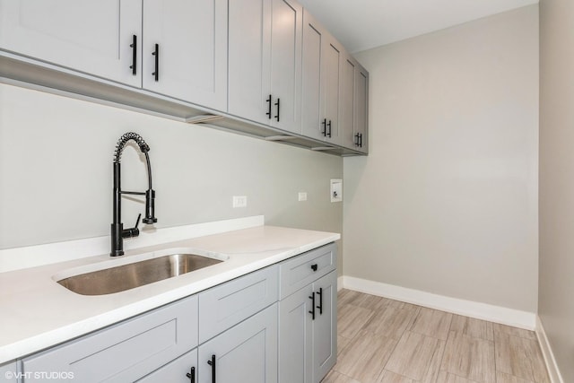 laundry room with washer hookup, sink, and cabinets