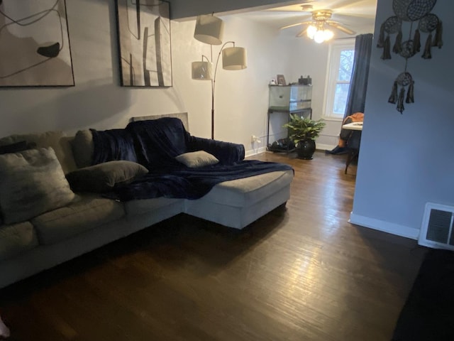 living room featuring ceiling fan and dark hardwood / wood-style floors