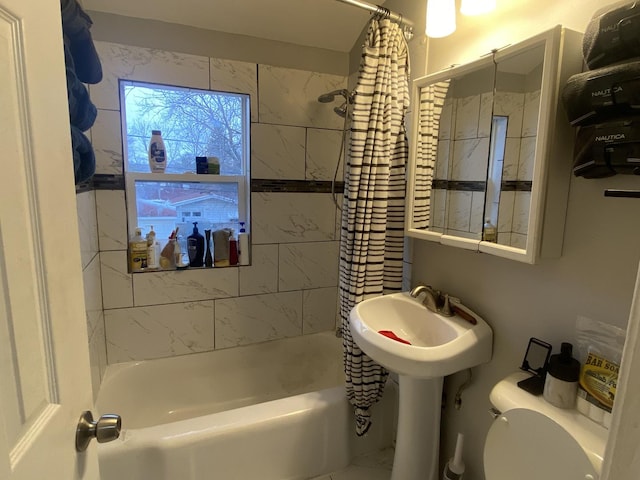 bathroom featuring shower / bathtub combination with curtain and toilet