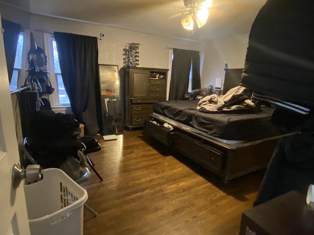 bedroom featuring ceiling fan and dark wood-type flooring