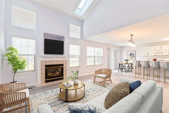 stairs featuring a tiled fireplace and hardwood / wood-style flooring