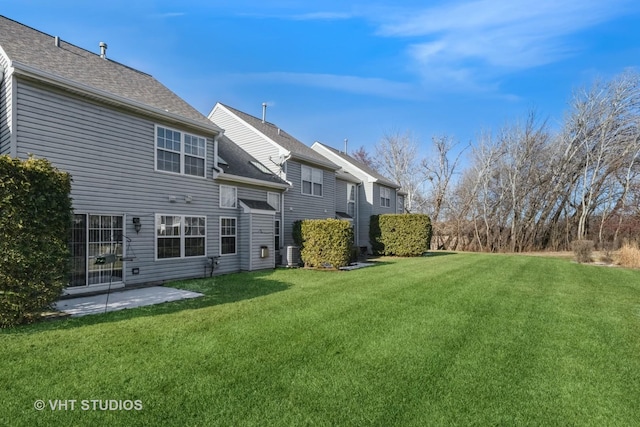 back of property featuring cooling unit, a yard, and a patio