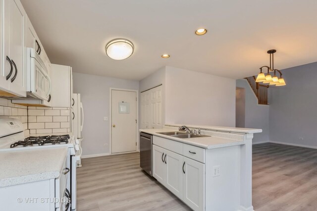 unfurnished living room featuring light hardwood / wood-style floors and an inviting chandelier