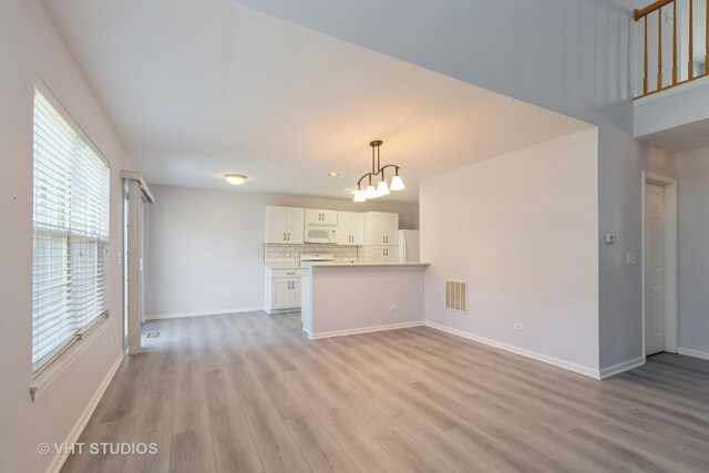 bonus room featuring lofted ceiling with skylight and light carpet