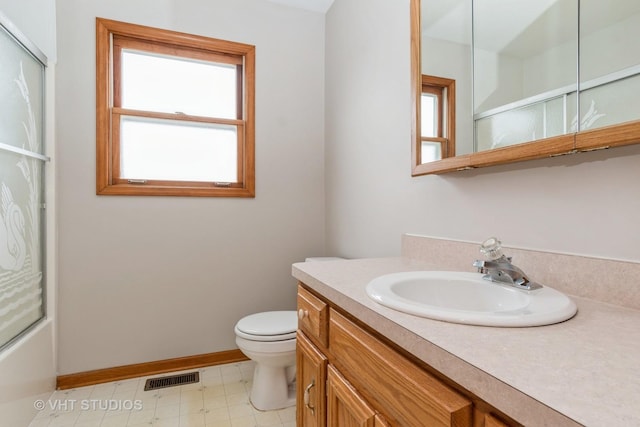 full bathroom with enclosed tub / shower combo, vanity, toilet, and a wealth of natural light