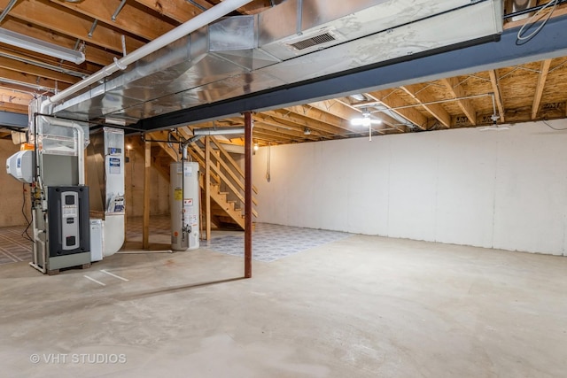 basement featuring water heater and heating unit