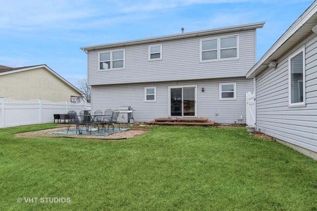 rear view of house with a yard and a patio area